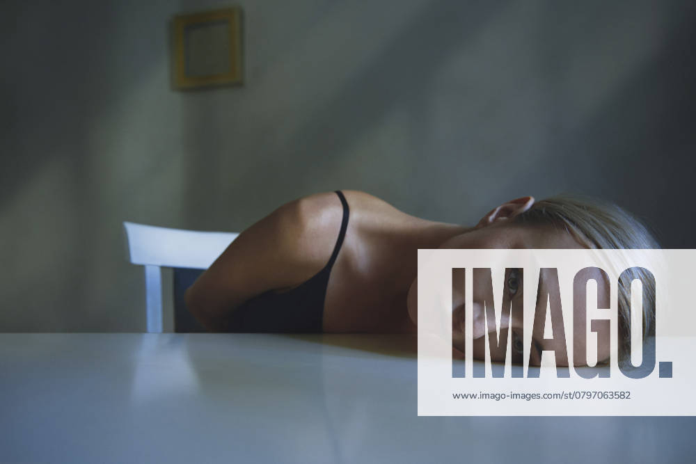 Tired woman lying on table model released, Symbolfoto, AZF00624