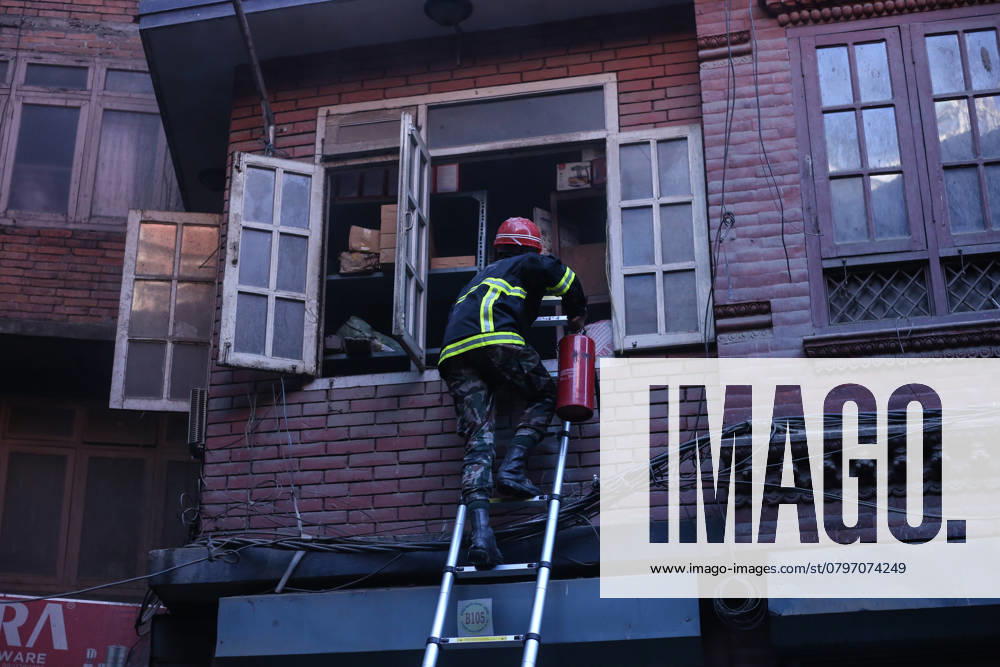 Fire In Kathmandu A Nepal Army personnel carries a fire extinguisher as he enters the home using a ladder to douse the fire in Kathmandu, Nepal, on January 23, 2025. Kathmandu Nepal