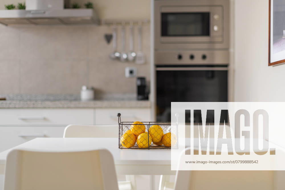 Metal basket with ripe yellow lemons on a white dining table. Blurred background of kitchen furniture and electronic equipment made of brushed durable metal along the wall , 49373400.jpg, kitchen, lemon, basket, table, vitamin, ripe, citrus, yellow, fruit, eating, acid, white, oven, house, background, culinary, food, fresh, indoor, juicy, light, gastronomy, healthy, room, wellbeing, cooking, cuisine, vivid, delicious, diet, homemade, ingredient, natural, organic, vegetarian, wooden, no people, exotic, interior, appartment, citron, color image, healthy eating, modern, nutrition, color, food and drink, light background, preparation, brunch RECORD DATE NOT STATED