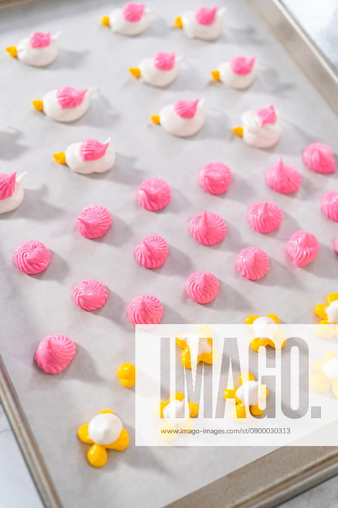 Piping meringue with piping bags into the baking sheet lined with parchment paper to bake Easter meringue cookies. , 49479900.jpg, Baked treat, Baking, Cookie, Cooking, Dessert, Easter, Food, Food coloring, Holiday, Meringue cookies, Paper, Parchment paper, Pastries, Recipe, Spring holiday, Sweet food, Sweets, making, pastry, preparing RECORD DATE NOT STATED