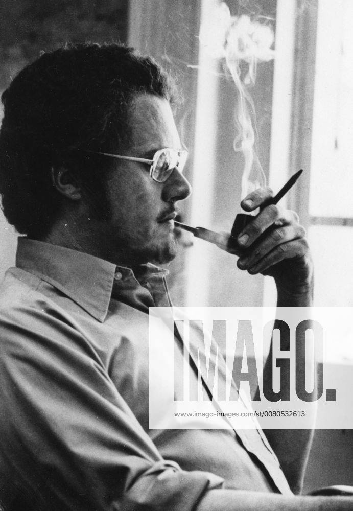 Cartoonist Patrick Oliphant smoking a pipe, 1975. 1023_05_72955final
