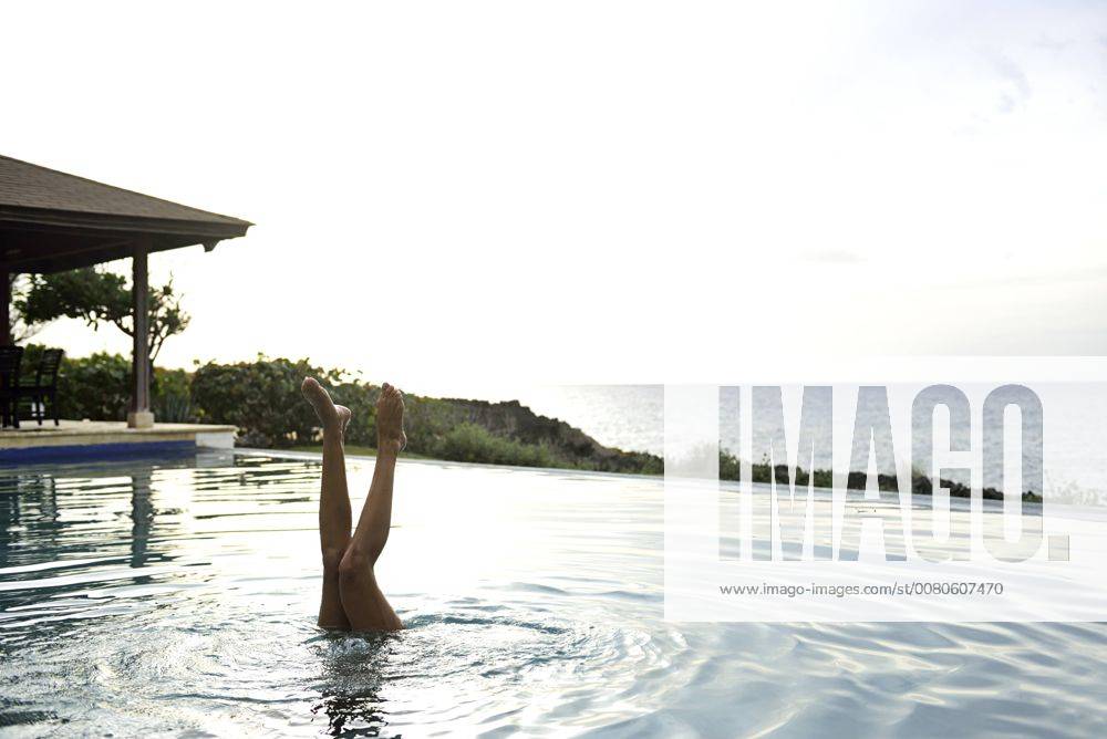 Legs of woman diving in swimming pool model released Symbolfoto ECPF00107