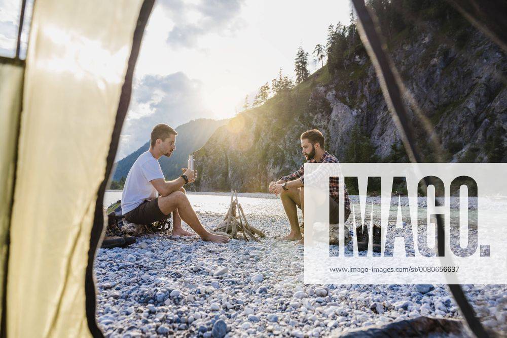 Germany, Bavaria, two hikers camping on gravel bank in the evening model released Symbolfoto DIGF02831