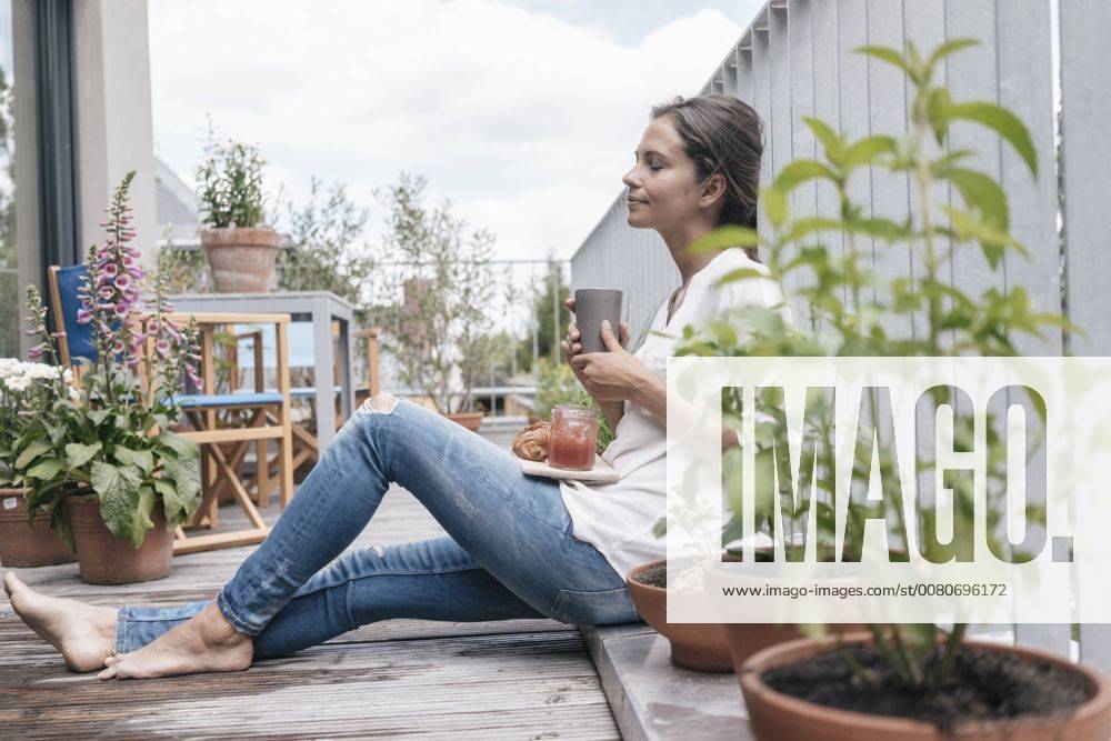 Woman relaxing on balcony model released Symbolfoto property released JOSF01634