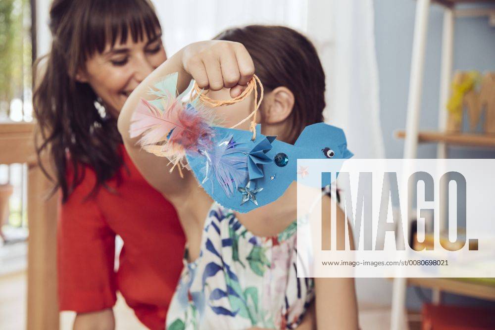 Mother and daughter playing with self made paper bird model released Symbolfoto property released MFF03804