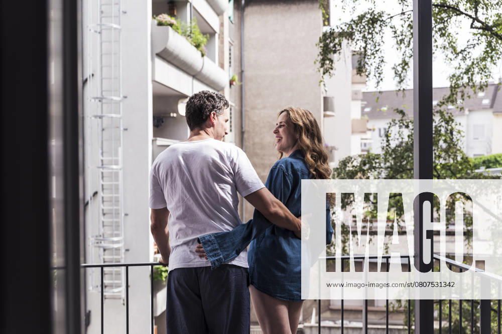 Couple enjoying a morning together on a balcony in an urban setting model released, Symbolfoto, UUF34133