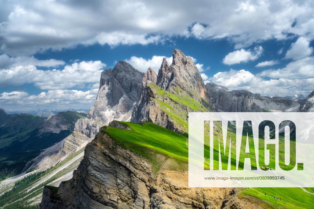 Aerial view of Seceda mountain in summer in Dolomites, Italy. Colorful landscape with mountain peaks, rocks, alpine meadows, trail, green grass, blue sky with clouds. Nature. Top view of Alps Model Released DenisBilytskyi_ID26964_778296_017