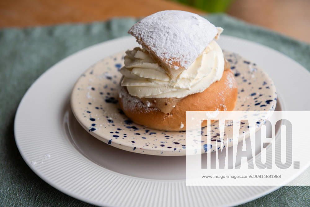 Typical Swedish semla with sweet cream on te blue textile. , 58612186.jpg, pastry, cream puff, sweet, bun, sticky, small, powdered sugar, dessert, hot drink, easter, gold, plate, icing, delicious, almond, traditional, healthy, bakery, macro, sweden, powder, bright, baked, white, food, group, swedish, cream bun, cream, whipped cream, fresh, soft, milk, treat, generative, bread, homemade, epicure, sugar, snack RECORD DATE NOT STATED