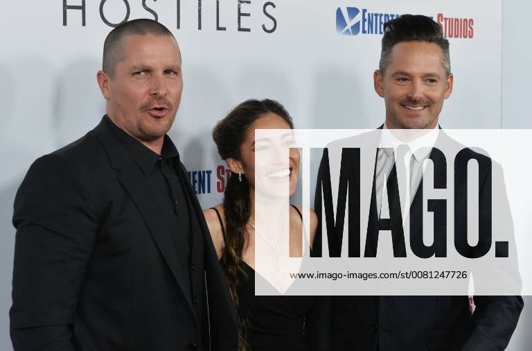 Cast members Christian Bale and Q orianka Kilcher join director Scott Cooper (R) on the red carpet during the premiere of the motion picture western Hostiles at the Academy of Motion Picture Arts & Sciences in Beverly Hills, California on December 14, 2017. Storyline: In 1892, a legendary Army captain reluctantly agrees to escort a Cheyenne chief and his family through dangerous territory. LAP2017121405 JIMxRUYMEN