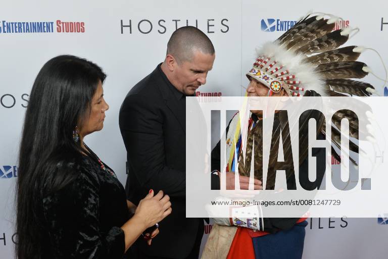 Cast member Christian Bale totes Chief Phillip Whiteman Jr. s eagle feathers as Lunette Two Bulls looks on during the premiere of the motion picture western Hostiles at the Academy of Motion Picture Arts & Sciences in Beverly Hills, California on December 14, 2017. Storyline: In 1892, a legendary Army captain reluctantly agrees to escort a Cheyenne chief and his family through dangerous territory. LAP2017121408 JIMxRUYMEN