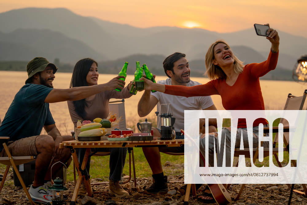 Beautiful Caucasian woman use mobile phone to selfie with her friend during camping and enjoy together near lake with sunset and they look happy for party outdoor., model released, , 59068286.jpg, outdoors, picnic, party, cheers, drink, eating, sunset, activity, campfire, carefree, casual, lifestyle, asian, beer, camp, adult, adventure, caucasian, enjoying, freedom, friends, friendship, fun, group, guitar, happiness, happy, holiday, joy, joyful, laughing, leisure, nature, outdoor, people, play, portrait, recreation, relaxation, sitting, summer, together, togetherness, travel, trip, twilight, vacation, weekend, young RECORD DATE NOT STATED