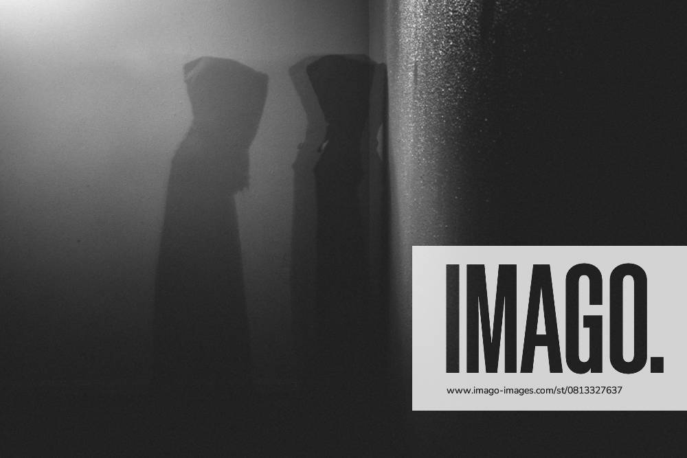 Dark hooded ghostly figure walks through dark wall Grimes, Iowa, United States R_LIPF250416-1704804-01