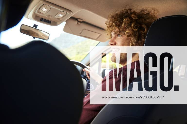 Young man driving car model released Symbolfoto SRYF00579
