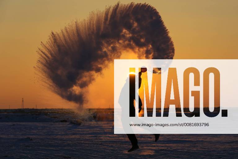 Beitun, China - A man throws hot water into the air which freezes immediately in minus 30 degree Celsius in Beitun, northwest China s Uygur Autonomous Region. Beitun China - ZUMAs145 20180125_zaa_s145_232