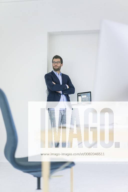 Businessman standing in office model released Symbolfoto property released MOEF00660