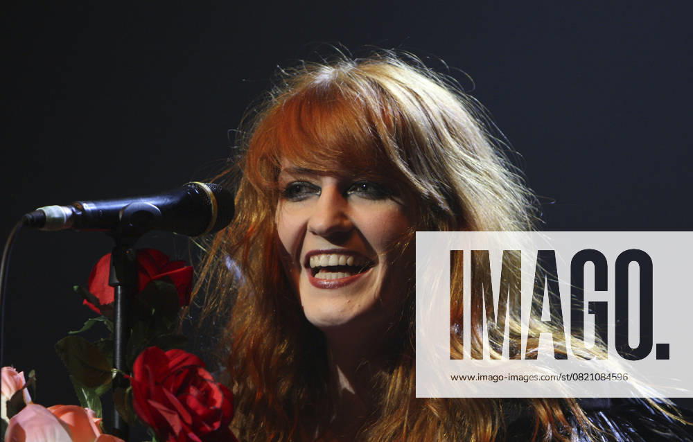 Tennage Cancer trust Concerts FLORENCE AND THE MACHINE aka FLORENCE WELCH performing live as part of the concerts in aid of Tennage Cancer trust, Royal Albert Hall, London, England, UK, March 24th 2009. microphone music gig concert on stage smiling portrait headshot CAP MAR Martin Harris London Great Britain