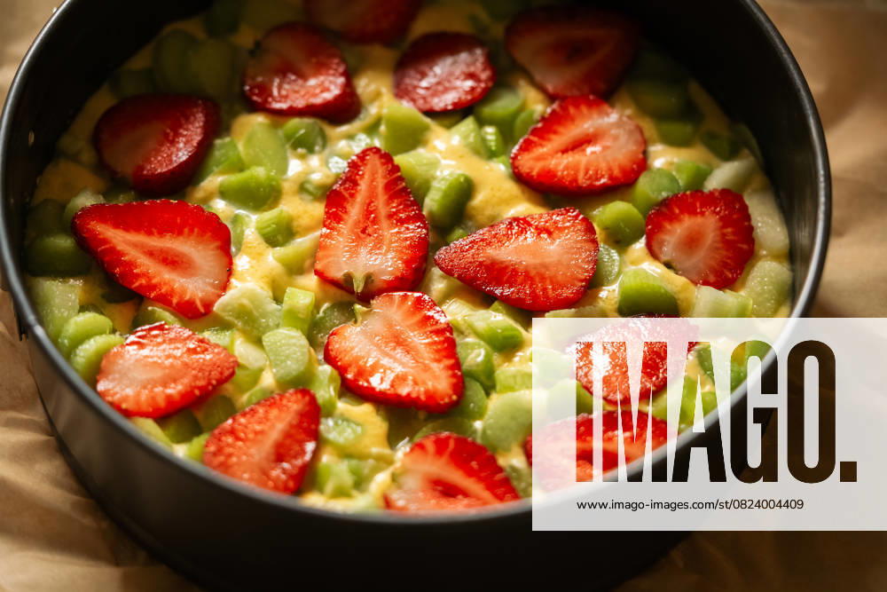 Homemade strawberry rhubarb cake with fresh ingredients Delight in the vibrant colors and flavors of a homemade strawberry rhubarb cake, beautifully arranged with fresh, juicy strawberries and tart rhubarb. Perfect for any occasion Model Released Ellsy_ID29794_1007202_002