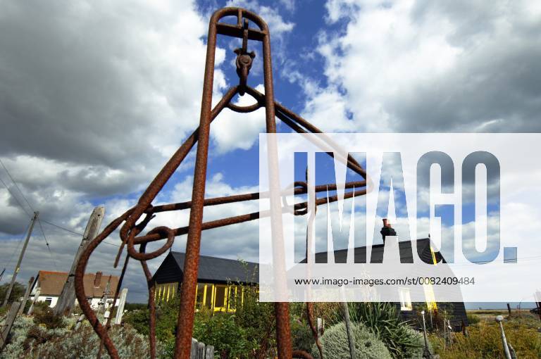 Picture by Roger Bamber: 1 September 2007 : Prospect Cottage, the former home of the late artist and film director Derek Jarman at Dungeness,on Romnet Marsh, Kent. The house and its dry shingle garden is photographed through one of his many sculptures made from iron and driftwood.,