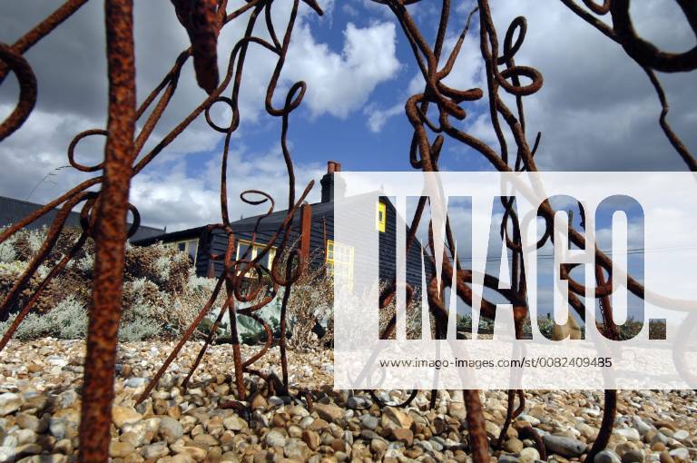 Picture by Roger Bamber: 1 September 2007 : Prospect Cottage, the former home of the late artist and film director Derek Jarman at Dungeness,on Romnet Marsh, Kent. The house and its dry shingle garden is photographed through one of his many sculptures made from iron and driftwood.,