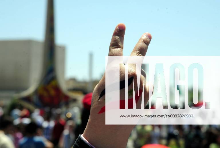 (180416) -- DAMASCUS, April 16, 2018 -- A Syrian makes a victory sign during a pro-government rally held at the Umayyad Square, in Damascus, Syria, on April 16, 2018. Thousands of Syrians in Damascus thronged the Umayyad Square celebrating the military victory in Eastern Ghouta despite the U.S.-led attack on Syrian military positions. ) (zf) SYRIA-DAMASCUS-PRO-GOVERNMENT-RALLY AmmarxSafarjalani