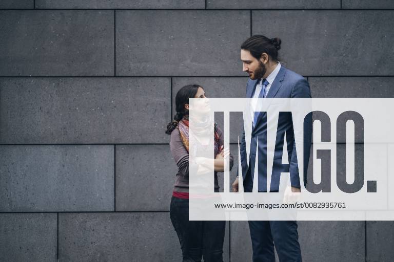 Businessman and woman looking at each other model released Symbolfoto JSCF00094