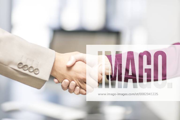 Close-up of businessman and businesswoman shaking hands model released Symbolfoto property released ZEF15085