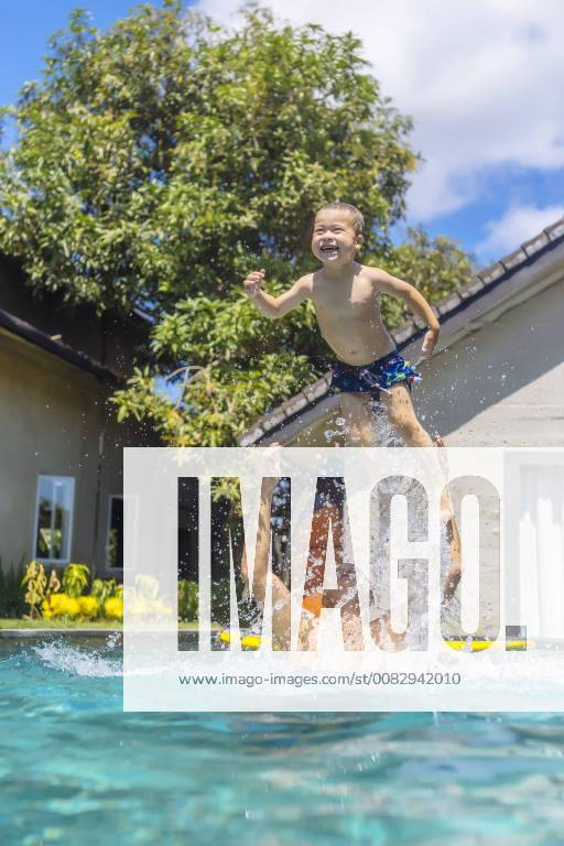 Father and son having fun in swimming pool model released Symbolfoto property released KNTF01095