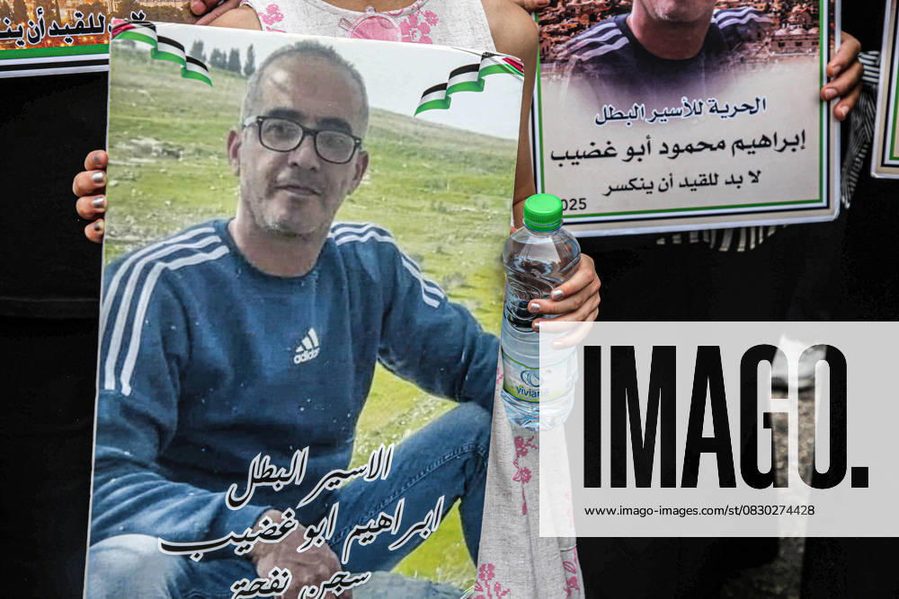 A portrait of a Palestinian prisoner is held during a solidarity rally demanding a prisoner exchange agreement between the Israeli government and Hamas. Nablus Palestine - ZUMAs197 20250812_aaa_s197_047