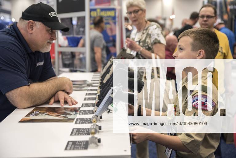 A convention attendee inspect a gun on the floor of the exhibition hall at the 147th National Rifle Association (NRA) Annual Meetings and Exhibits at the Kay Bailey Hutchison Convention Center in Dallas on May 5, 2018. DAL20180505325 SERGIOxFLORES