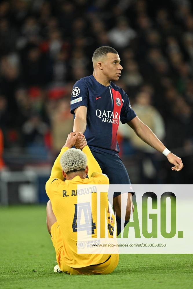 Paris Saint-Germain v Barcelona - UEFA Champions League PARIS, FRANCE - APRIL 10: Kylian Mbappe (7) of Paris Saint-Germain helps Ronald Araujo of Barcelona after a position during the UEFA Champions League quarter finals first leg football match between Paris Saint-Germain and FC Barcelona at Parc des Princes in Paris, France on April 10, 2024. France World. Editorial use only. Please get in touch for any other usage.
