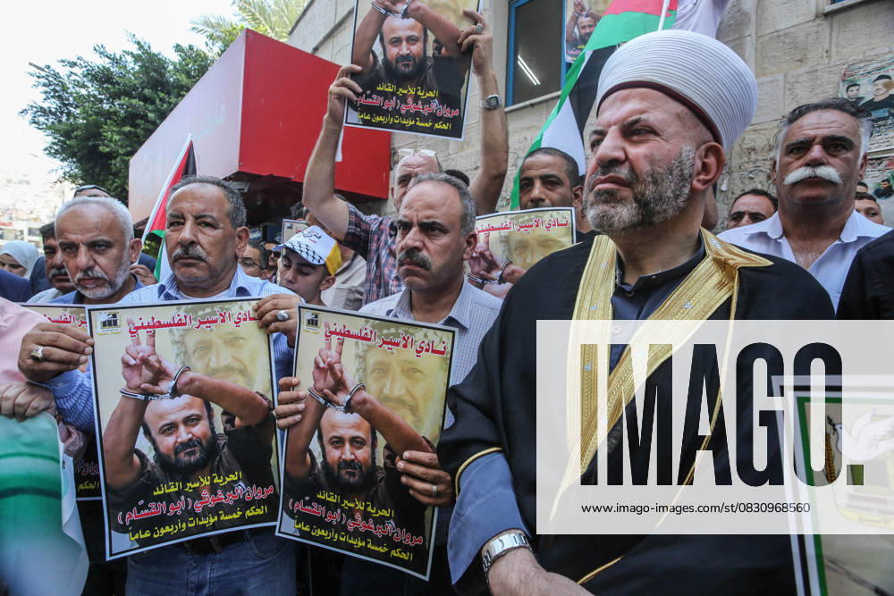 Protesters hold pictures of Palestinian prisoner Marwan Barghouti, who is serving a five life sentences and 40 years in Israeli prisons, during a protest demanding his release and the release of all prisoners in the city of Nablus. Nablus Palestine - ZUMAs197 20250820_aaa_s197_053