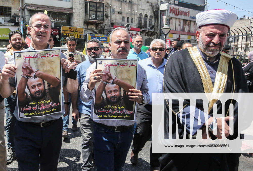 Protesters hold pictures of Palestinian prisoner Marwan Barghouti, who is serving a five life sentences and 40 years in Israeli prisons, during a protest demanding his release and the release of all prisoners in the city of Nablus. Nablus Palestine - ZUMAs197 20250820_aaa_s197_054