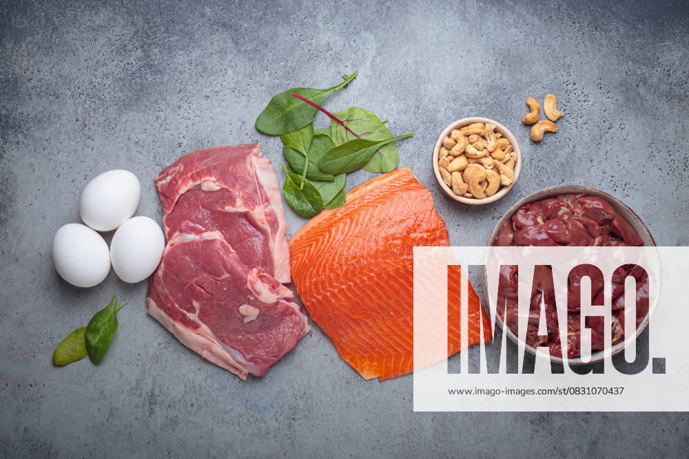 Food ingredients high in iron for health and wellness top view on grey concrete background Fresh salmon fillet, raw beef, nutritious eggs, spinach, nuts cashews and liver arranged on a gray background, iron rich foods essential for a balanced diet concept, 63688216.jpg RECORD DATE NOT STATED