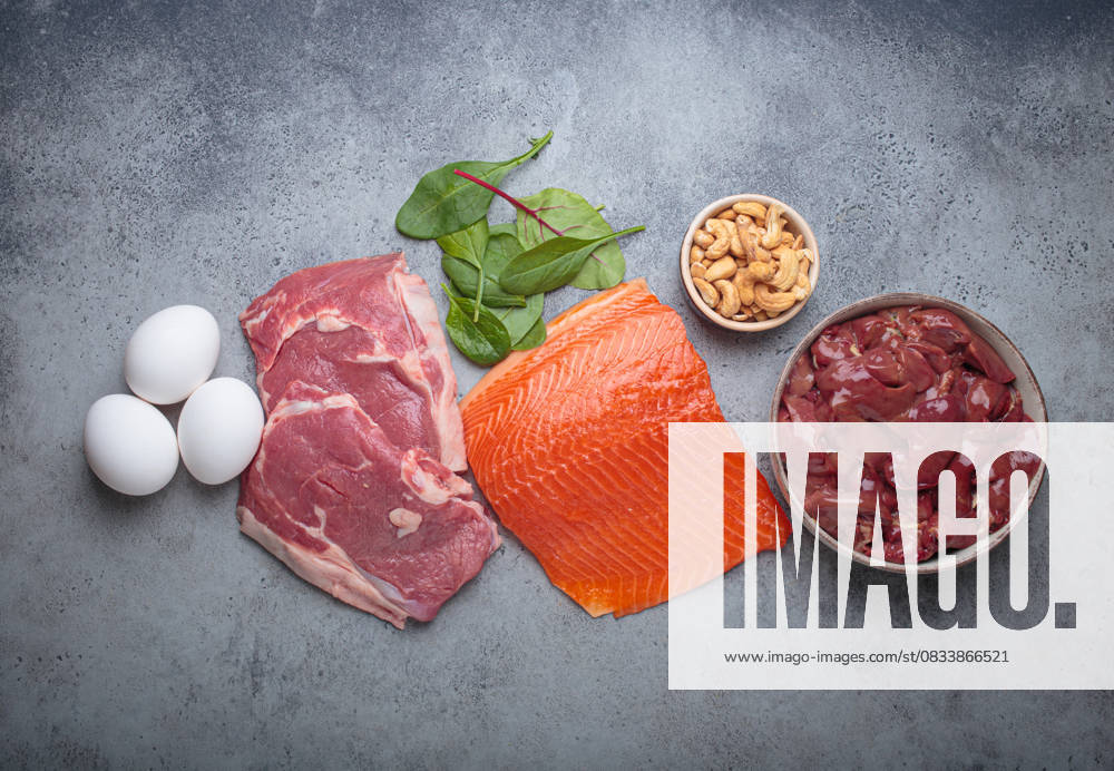 Food ingredients high in iron for health and wellness top view on grey concrete background Fresh salmon fillet, raw beef, nutritious eggs, spinach, nuts cashews and liver arranged on a gray background, iron rich foods essential for a balanced diet concept, 94607644.jpg RECORD DATE NOT STATED