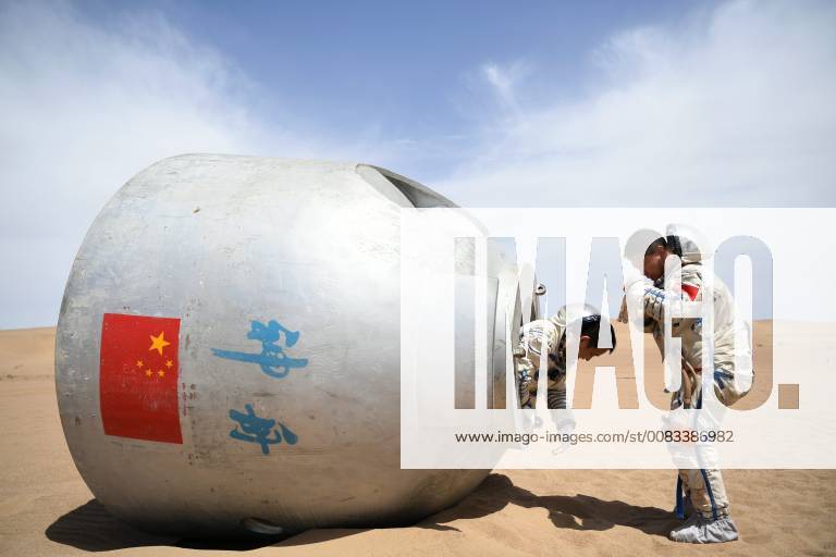 (180527) -- LANZHOU, May 27, 2018 -- Taikonauts Nie Haisheng (L) and Liu Wang exit from a re-entry capsule during a wilderness survival training in the Badain Jaran Desert in northwest China s Gansu Province, May 17, 2018. Fifteen Chinese taikonauts have just completed desert survival training deep in the Badain Jaran Desert near Jiuquan Satellite Launch Center in northwest China. Organized by the Astronaut Center of China (ACC), the program was designed to prepare taikonauts with the capacity to survive in the wilderness in the event their re-entry capsule lands off target. ) (lmm) CHINA-GANSU-TAIKONAUT-DESERT-WILDERNESS-SURVIVAL-TRAINING (CN) ChenxBin