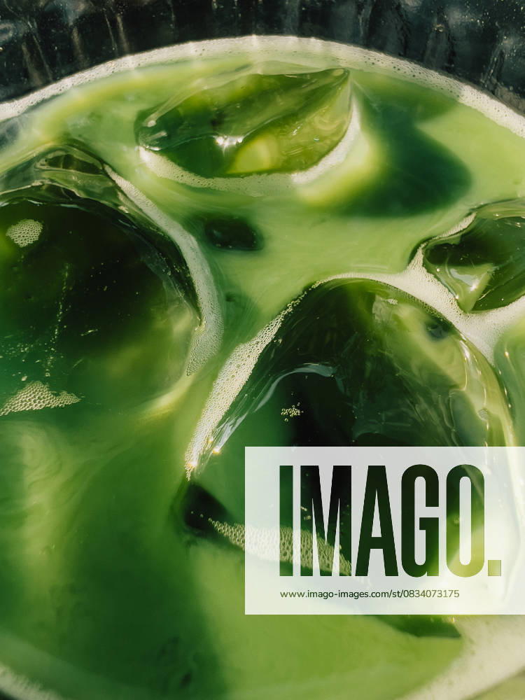 Iced Matcha Latte with Ice Cubes Melting in Glass. Close up of refreshing iced matcha latte, showcasing vibrant green color and melting ice cubes in glass, creating visually appealing summer beverage Iced Matcha Latte with Ice Cubes Melting in Glass. Close up of refreshing iced matcha latte, showcasing vibrant green color and melting ice cubes in glass, creating visually appealing summer beverage, 94974572.jpg RECORD DATE NOT STATED
