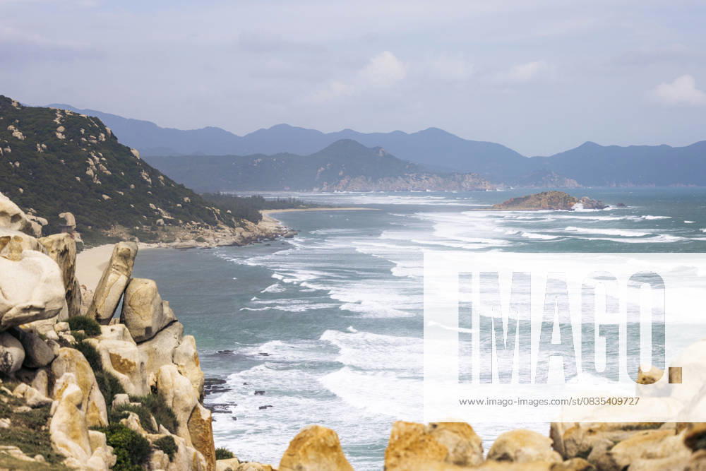 Coast line of Ninh Hai District in Ninh Thuan, Vietnam Rocky coastline with waves crashing on the shore under a cloudy sky. Ninh Hai District in Ninh Thuan, Vietnam Ninh Hai District Ninh Thuan Vietnam cane03892