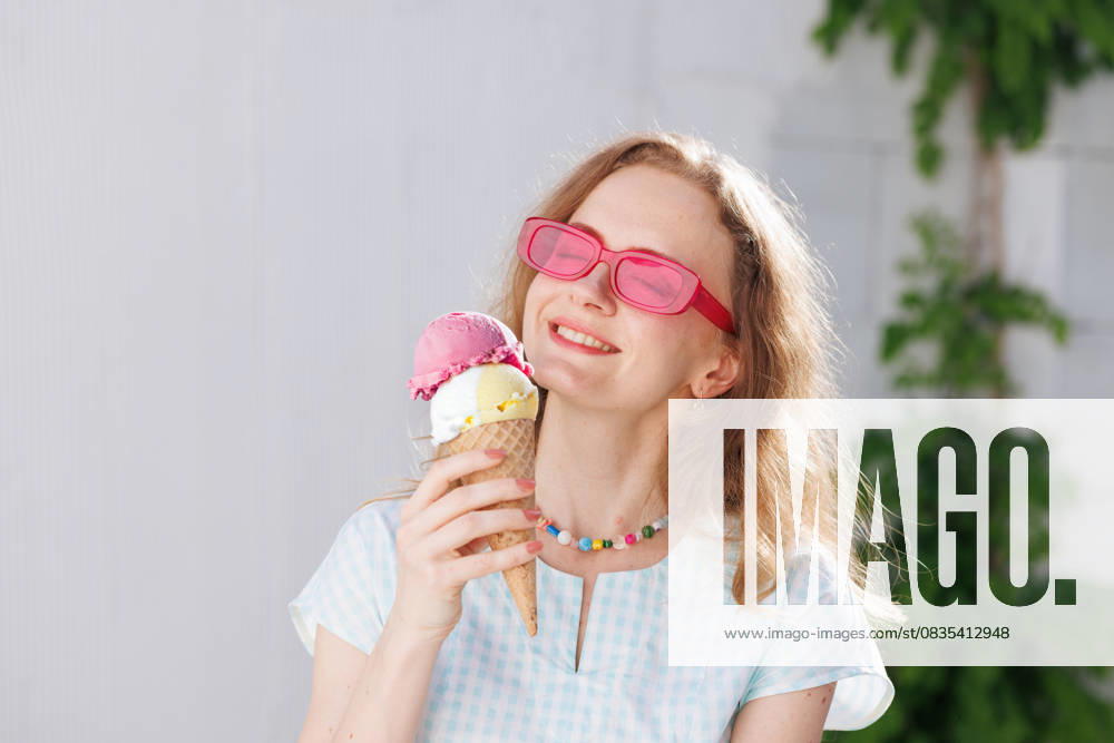 Girl in pink glasses eats ice cream balls in the hot summer, escape from the heat girl eats ice cream balls in hot summer, escape from the girl in pink glasses eats ice cream balls in the hot summer, escape from the heat, model released, , 60686824.jpg RECORD DATE NOT STATED