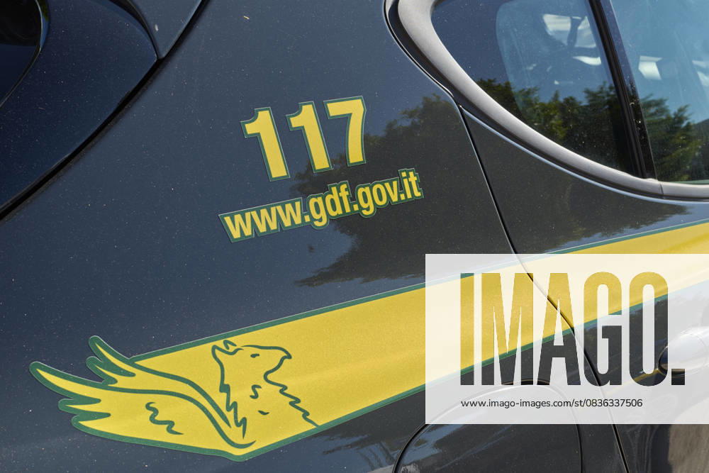 Italian Police Officers On Duty In Urban Area A close-up of an Italian Guardia di Finanza patrol car displays the emergency number 117, representing law enforcement and financial police presence in Bari, Italy, on September 22, 2025. Bari Italy