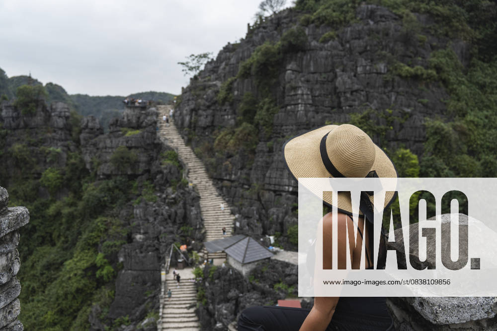 Tourist with hat overlooking green mountains at Ninh Vinh Vietnam model released, Symbolfoto property released, PNAF06762