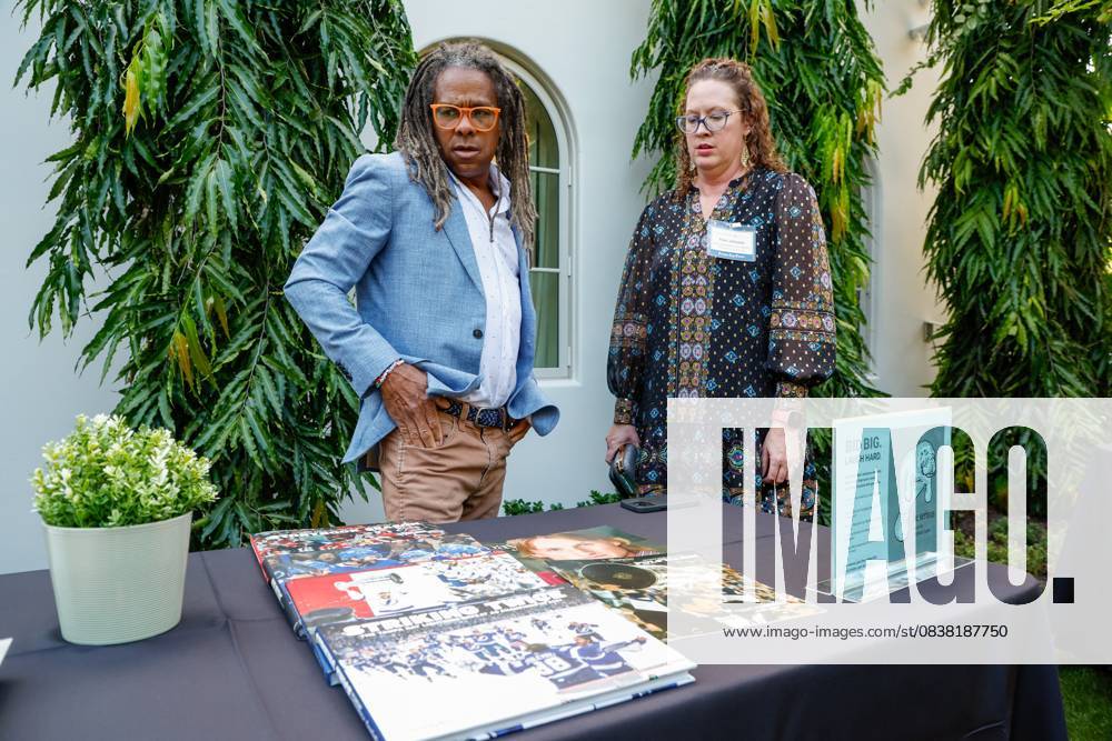 Tampa Bay Times photojournalist Dirk Shadd and Traci Johnson, managing editor for sports, production and visuals, look over a table they just set up with books and magazines during the annual Cocktails and News fundraiser event on Thursday, Oct. 23, 2025, in St. Petersburg. St. Petersburg USA - ZUMAs70_ 20251023_zan_s70_056