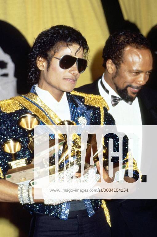 Michael Jackson with Quincy Jones at the 26th Annual Grammy Awards, February 1984. Jackson wins Record of the Year and Best Vocal Performance, Male for Thriller , Best R&B Vocal Performance, Male and Best New R&B Song for Billie Jean , Best Recording for Children for E.T. The Extra Terrestrial and Producer of the Year (Non Classical), shared with Quincy Jones. © Gary Gershoff MediaPunch Credit all Uses