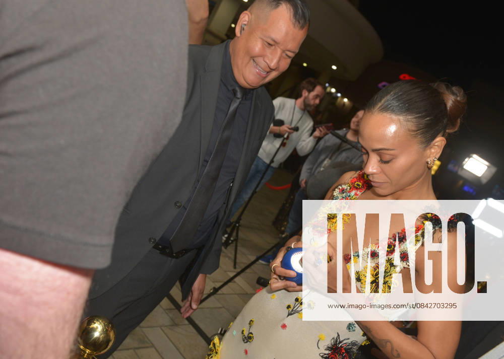 MIAMI, FLORIDA - DECEMBER 12: Zoe Saldana sign autograph for fans at the Miami Special Screening of Avatar: Fire and Ash at AMC Sunset Place 24 in Miami, Florida on December 12, 2025.