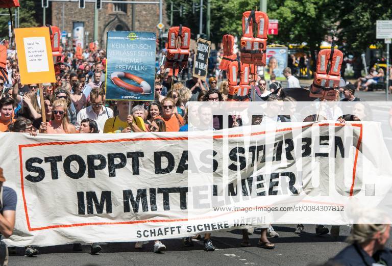 Tausende Menschen demonstrierten am Samstag (07.07.2018) in Berlin fuer die Seenotrettung von Fluechtlingen im Mittelmeer (Foto). Unter dem Banner Stoppt das Sterben im Mittelmeer zogen nach Veranstalterangaben am Samstagnachmittag 12.000 Menschen vom Berliner Alexanderplatz zum Regierungsviertel in Berlin-Mitte. Die Polizei sprach mehreren tausend Teilnehmern. Zu den bundesweiten Protesten hatte ein Buendnis Seebruecke aus 13 Fluechtlingsinitiativen und zivilgesellschaftliche Gruppen aufgerufen. Weitere Demonstrationen gab es im Laufe des Samstags in Zwickau, Hannover, Bremen, Giessen, Leipzig, Hannover, Heidelberg und Frankfurt. (Siehe epd-Meldung vom 07.07.2018) Tausende demonstrieren in Berlin fuer Seenotrettung im Mittelmeer