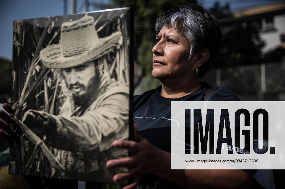 Commemoration of Fidel Castro in Mexico City MEXICO CITY, MEXICO - NOVEMBER 27: A woman holds Fidel Castro s portrait during a commemoration ceremony of Fidel Castro outside the Cuban Embassy in Mexico City, Mexico on November 27, 2016. Fidel Castro, the former leader of Cuba, died at the age of 90 on November 25, 2016. Mexico World. Editorial use only. Please get in touch for any other usage.