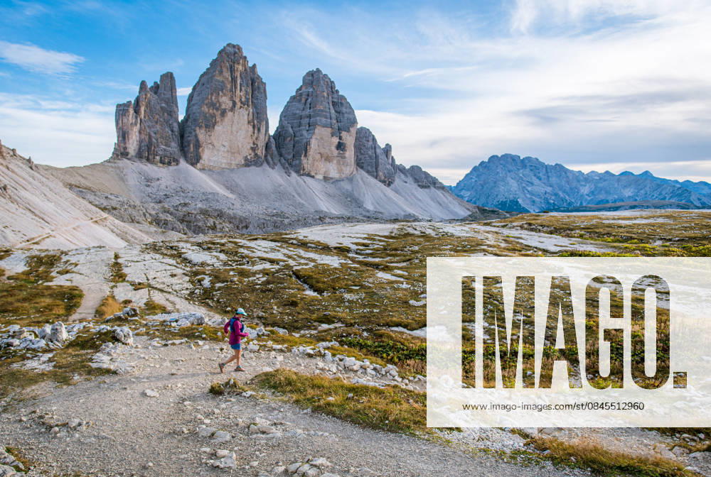 Woman trail running through the dramatic Tre Cime di Lavaredo Sexten, Trentino-South Tyrol, Italy CR_BRDO260112-1935402-01 ,model released, Symbolfoto