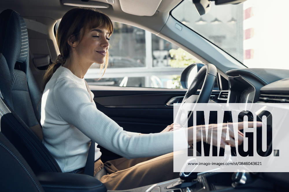 Woman using touchscreen in a modern car indoors portrait model released, Symbolfoto, JSRF04194