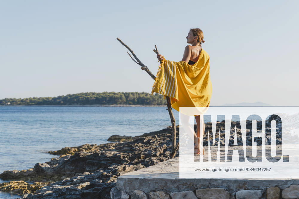 Woman enjoying summer vacation on seaside rocky beach in nature model released, Symbolfoto, NDEF03188