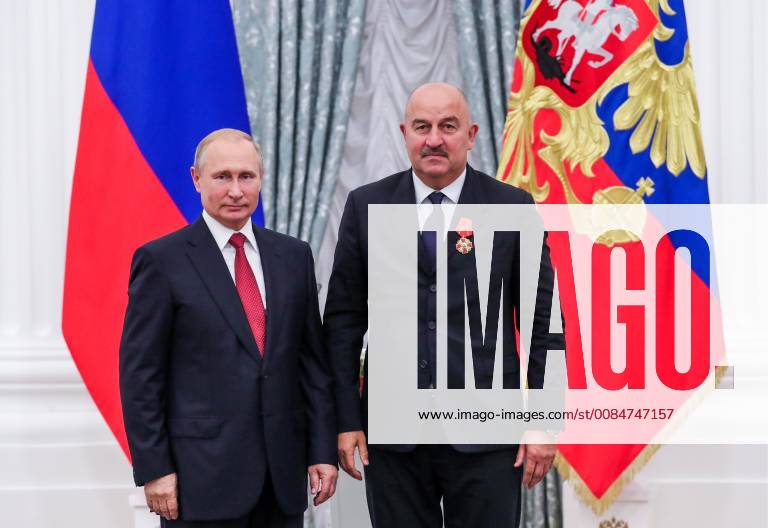 MOSCOW, RUSSIA – JULY 28, 2018: Russia s President Vladimir Putin (L) awards head coach Stanislav Cherchesov an Order of Alexander Nevsky at a ceremony to present state decorations certificates of merit to Russian men s national football team players and coaches following the 2018 FIFA World Cup at the Moscow Kremlin. Mikhail Klimentyev Russian Presidential Press and Information Office TASS TS08B13C
