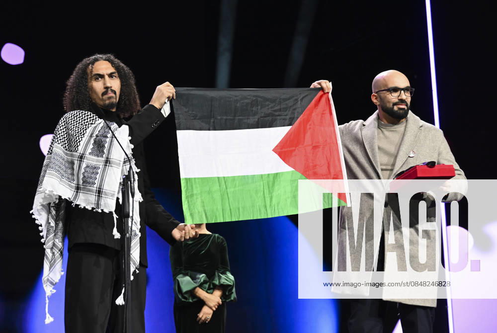 76th Berlin International Film Festival BERLIN, GERMANY - FEBRUARY 21: Director Abdallah Alkhatib (L) takes to the stage carrying the Palestinian flag after winning the Best Feature Film Award with his film Chronicles From the Siege at the 76th Berlin International Film Festival (Berlinale) in Berlin, Germany, on February 21, 2026. Halil Sagirkaya Anadolu Berlin Germany. Editorial use only. Please get in touch for any other usage.